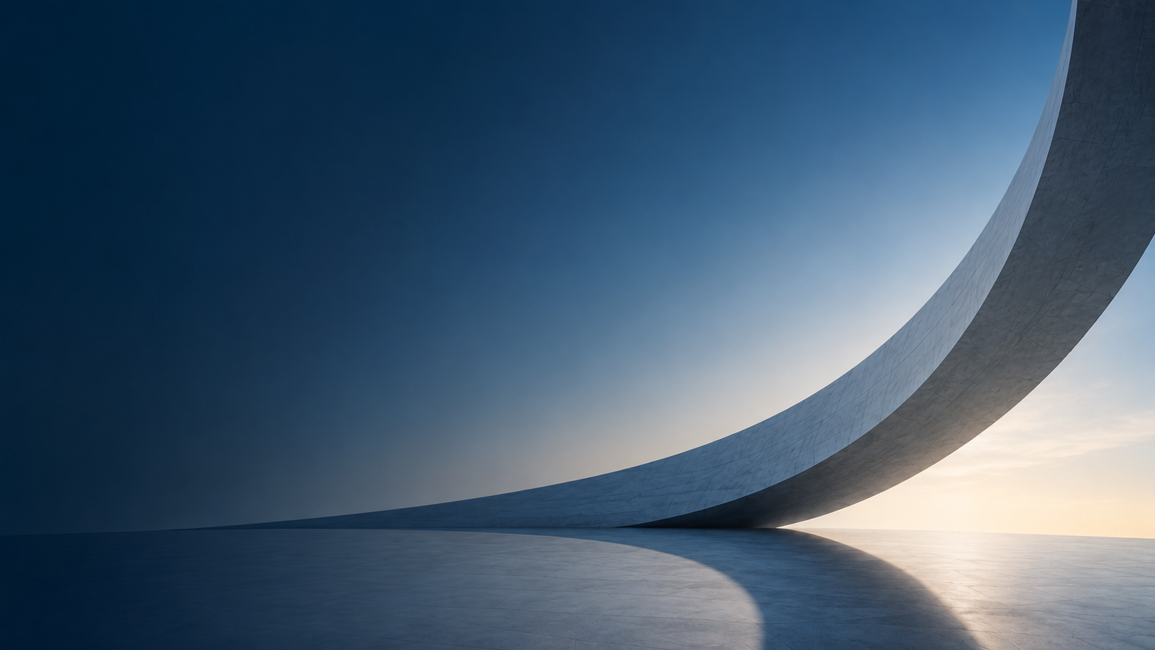 A sweeping architectural concrete arc against a dawn sky